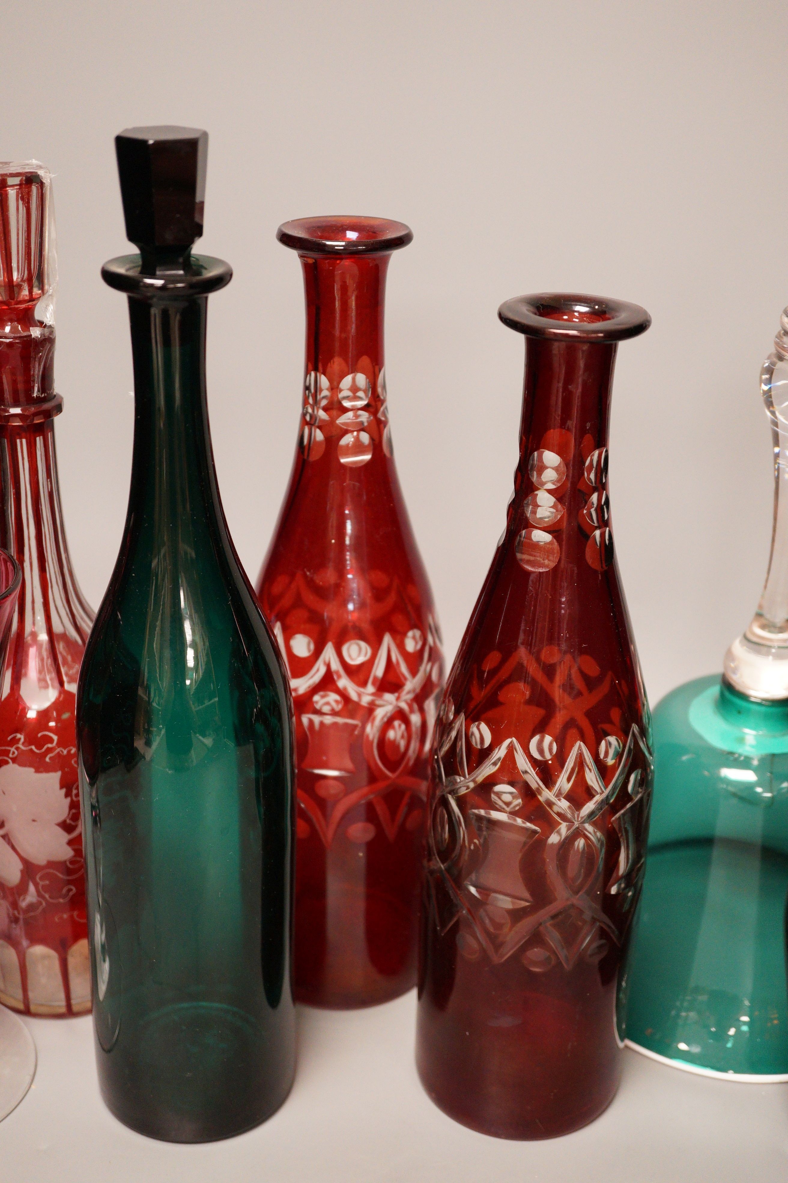 A pair of cut ruby flashed glass decanters, late Georgian emerald green glass decanter, and four other items